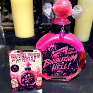 May include: A round glass bottle filled with bright pink liquid, topped with a pink sphere wrapped in clear plastic. A black collar features a pink teardrop charm. The label reads Bubblegum From Hell! with a devil illustration and skull graphic.