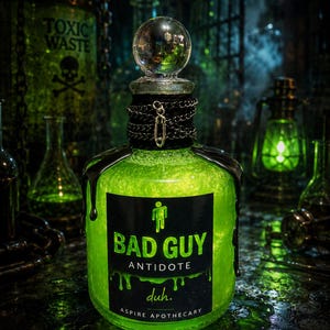 May include: A glass bottle filled with a glowing neon green liquid, topped with a clear spherical stopper. The neck is wrapped in a black chain with a safety pin. A black label reads BAD GUY ANTIDOTE, duh. and ASPIRE APOTHECARY with a stick figure icon.