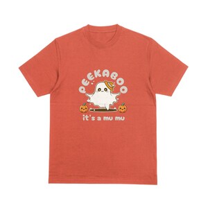May include: Orange t-shirt with a white ghost wearing a hat and the text "Peekaboo it's a mu mu" with two pumpkins on either side of the ghost.