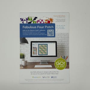May include: A product package with the title "Fabulous Four Patch" is displayed. The package includes software for designing quilts. A computer monitor shows a quilt design. The package also features the "GO! QUBE" logo.
