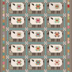 May include: A patchwork quilt featuring a repeating pattern of sheep with heart-shaped designs. The sheep are white with black faces and legs, set against a gray background with a teal grid and floral accents. The quilt's border is a mix of colorful shapes.