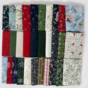 May include: A collection of folded fabric squares featuring various holiday-themed patterns including red, green, navy blue, and cream colors. The prints display motifs such as snowflakes, holly leaves, birds, and decorative stripes in a grid layout.