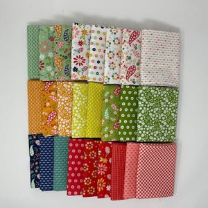 May include: A collection of folded fabric squares in various patterns and colors. Designs include floral, paisley, polka dots, and gingham. Colors range from green, yellow, and orange to red, pink, and blue.