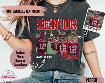 May include: A dark gray t-shirt with the word "SENIOR 2026" in red block letters. The shirt features three photos of football players and the word "Mom" in red script. Text on the shirt includes "Custom Player Name or Team Name" and "Upload Photo."