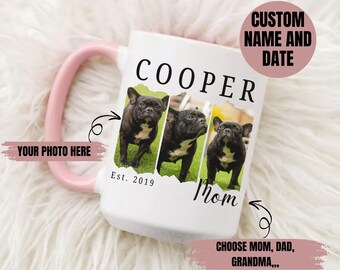 May include: White ceramic mug with a pink handle featuring three photos of a black French Bulldog. The mug has the name "COOPER" printed on it, along with the text "Mom" and "Est. 2019". The mug also includes the text "YOUR PHOTO HERE" and "CHOOSE MOM, DAD, GRANDMA..."