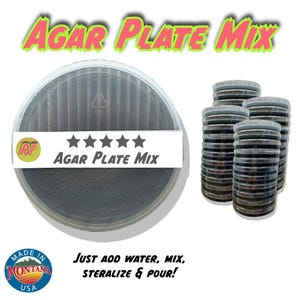May include: A clear plastic container with a black agar plate mix inside. The container has a white label with the text "RF AGAR PLATE MIX" and five stars. The text "AGAR PLATE MIX" is written in large, pink letters on a green background at the top of the image. The text "JUST ADD WATER, MIX, STERILIZE & POUR!" is written in black letters on a white background at the bottom of the image. The text "MADE IN MONTANA USA" is written in black letters on a white background in a circle with a mountain range inside.