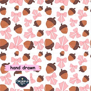 May include: A repeating pattern on a white background featuring brown acorns with dark brown caps and light pink bows. A pink rectangular label with the text hand drawn and a circular logo with the text TWINKLE TRAIL CO. are visible.
