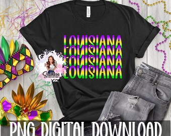 May include: Black t-shirt with a graphic design of the word "Louisiana" repeated four times in green, purple, and yellow. The text is in a bold, blocky font.