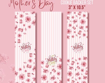 May include: Set of three pink and white cookie backer sheets with a floral pattern and the text "Happy Mother's Day". The sheets are 3 inches by 10.5 inches.