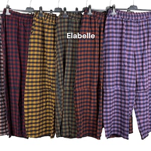 May include: Six pairs of wide-leg trousers with elastic waistbands, each featuring a distinct checkered pattern in colours including pink, red, yellow, green, orange, and purple. The word Elabelle is printed in white text above the trousers.