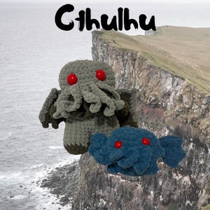 May include: Two crocheted plush toys, one green and one blue, depicting the fictional creature Cthulhu. The green Cthulhu has red eyes and tentacles. The blue Cthulhu has red eyes and a rounded body. The toys are on a cliff overlooking a body of water.