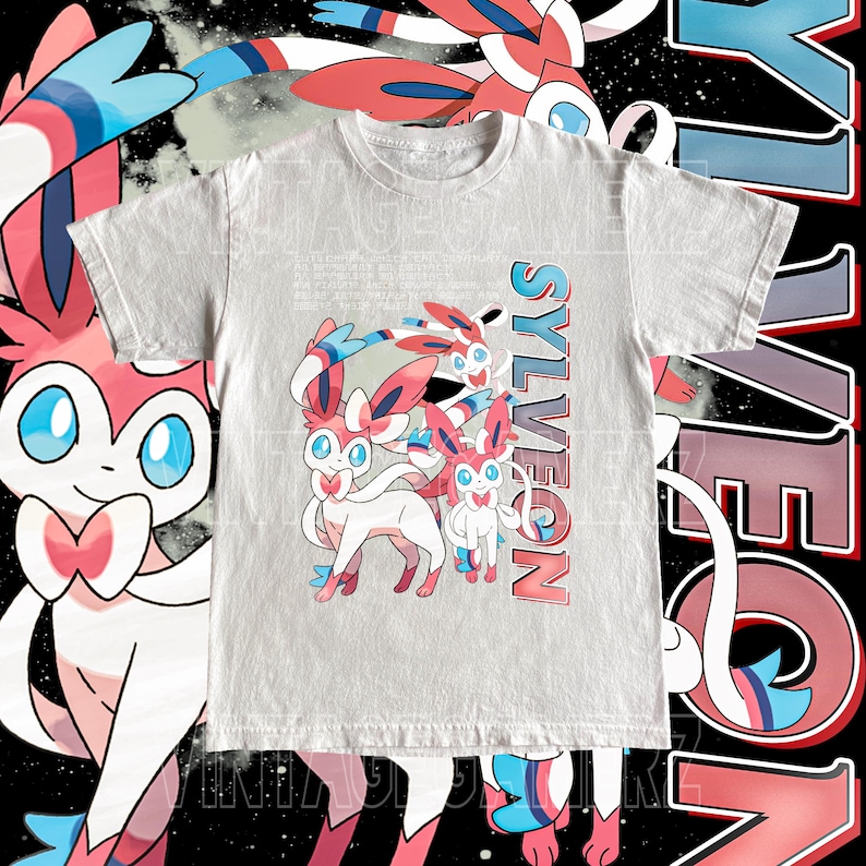 May include: A light gray t-shirt featuring a Sylveon graphic. The design includes multiple Sylveon characters in pink, white, and blue, with the word "Sylveon" in a gradient font. The background is black with white and pink accents.