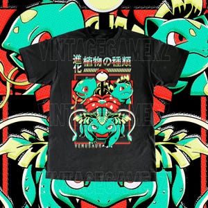 May include: Black t-shirt with a graphic of a Venusaur evolution line. The design includes the text "VINTAGEGAMERZ" and Japanese text. The background has a repeating pattern of green and red elements.