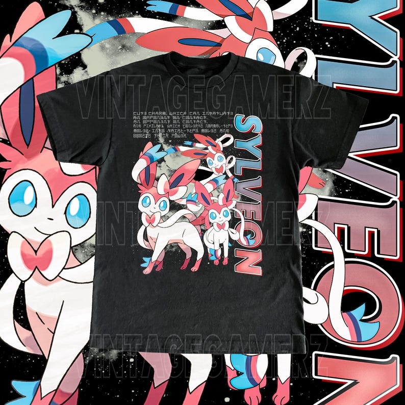 May include: Black t-shirt featuring a Sylveon graphic with pink, white, and blue accents. The design includes the word "SYLVEON" in a vertical font and Japanese text. The shirt has a vintage gamer aesthetic.