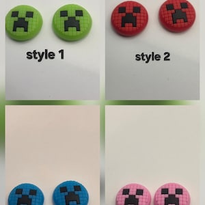 May include: Four sets of round, decorative buttons with a pixelated face design. The buttons are in green, red, blue, and pink, each with a black face. The text "style 1", "style 2", "style 3", and "style 4" is below each set.