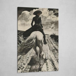 May include: Black and white print of a person riding a white horse on a dirt road. The person is wearing a wide-brimmed hat and a long black dress. The sky is filled with dramatic clouds, creating a vintage, western aesthetic.