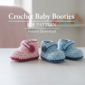 May include: Crochet Baby Booties PDF pattern. The image shows two baby booties, one pink and one blue, with button closures. The booties are handmade and sit on a white surface. The text "Crochet Baby Booties PDF Pattern Instant Download" is at the top.