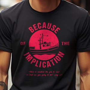 May include: A black t-shirt with a red circle graphic featuring a boat and the text "Because of the Implication". The text below the circle reads "There is nowhere for you to run! What are you going to do? Say no!"