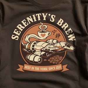 May include: Dark brown t-shirt with a circular design. The design includes the text "SERENITY'S BREW", a spaceship, a coffee cup with a heart, coffee beans, and the text "BEST IN THE VERSE SINCE 2517".