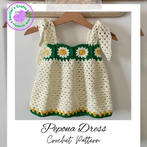 May include: A cream-coloured, handmade crochet dress with daisy accents in green and yellow. The dress has a square neckline and straps, with the text "Pepona Dress Crochet Pattern" at the bottom.