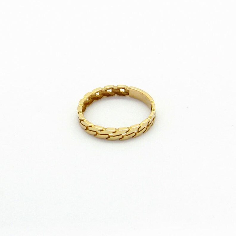 May include: A gold ring with a chain-link design.