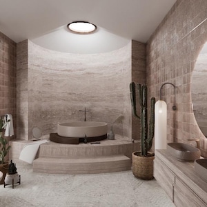 May include: A modern bathroom with a neutral color palette. Features include a round soaking tub, a large illuminated mirror, and a double vanity with oval sinks. The space is decorated with a cactus and other decorative elements.