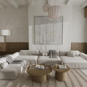 May include: A modern living room with a large sectional sofa, two round wooden coffee tables, and a dining table. The room features neutral tones, a large abstract painting, and decorative pendant lights.