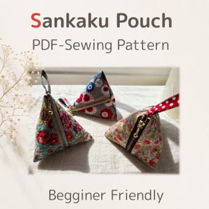 May include: Three triangular Sankaku pouches with floral patterns and zipper closures. One pouch has a blue and red floral design, another has a red and white polka dot strap, and the third has a floral pattern with a gold zipper. The text "Sankaku Pouch PDF-Sewing Pattern" is at the top.