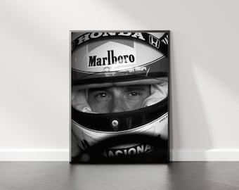 May include: Black and white photograph of a racing driver wearing a helmet with the Marlboro logo and Honda branding. The driver's eyes are visible through the visor.