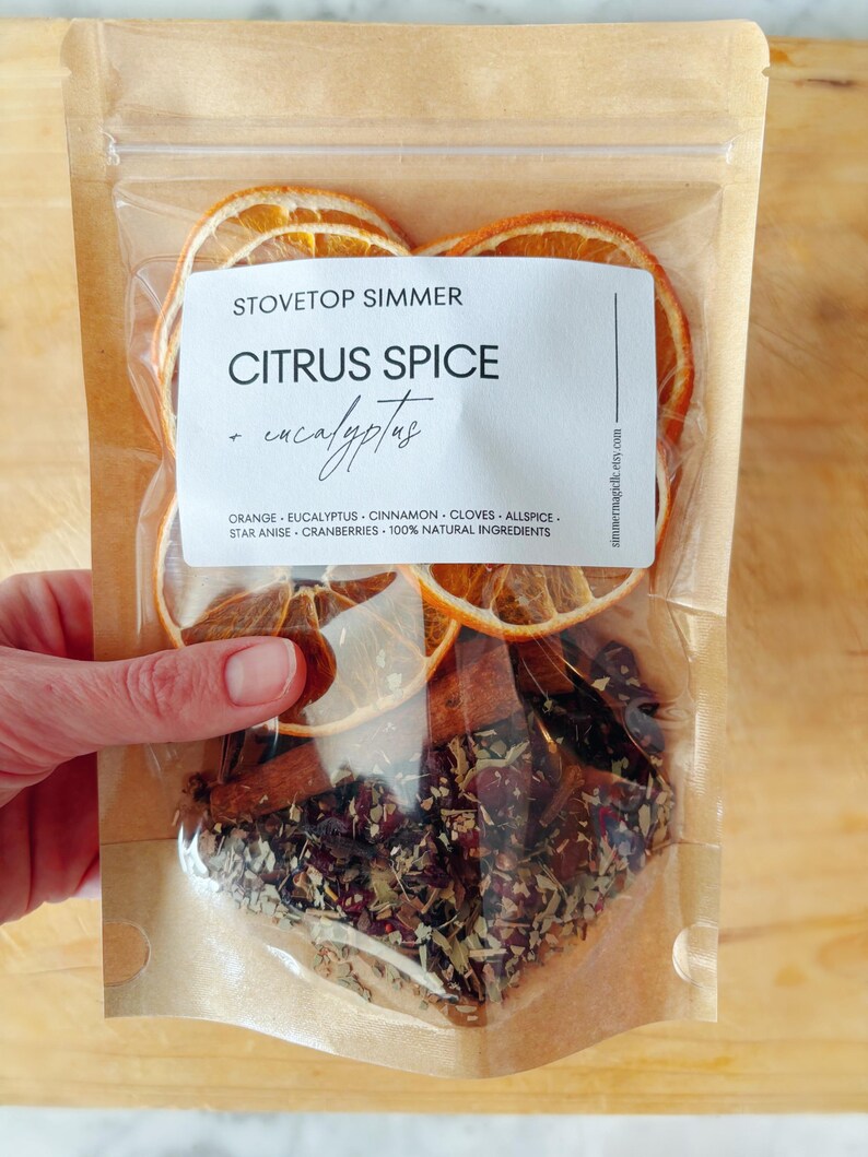 Hand holding a bag of citrus spice stovetop potpourri