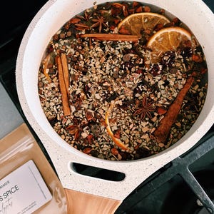 Simmer pot on stovetop with spices and citrus slices in water
