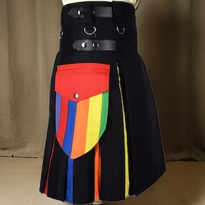 May include: A black kilt with a rainbow-colored stripe down the side and a red pocket with a rainbow-colored flap. The kilt has a leather belt with buckles and straps.