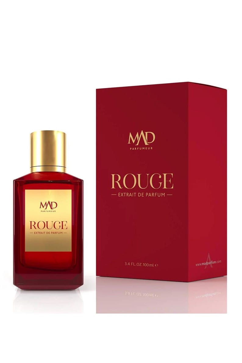 May include: A red perfume bottle with a gold cap and a matching red box. The bottle and box both feature the text "ROUGE - EXTRAIT DE PARFUM" and the brand logo "MAD PARFUMEUR". The bottle contains 100 ml of perfume.