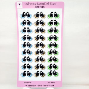 May include: A sheet of 27 pairs of adhesive resin doll eyes. The eyes are medium size and come in three colors: blue, brown, and green. The sheet is labeled "Adhesive Resin Doll Eyes BDE003" and "Medium W 13mmxH 15mm / W 0.51"xH".