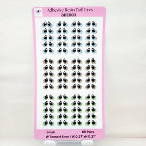 May include: A sheet of 60 pairs of small adhesive resin doll eyes. The eyes are in three colors: blue, brown, and green. Each eye is about 0.27 inches wide and 0.31 inches tall.