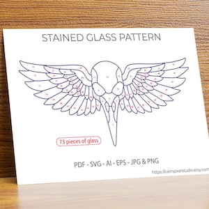 May include: A white paper featuring a stained glass pattern of a bird-like figure with wings. The text "STAINED GLASS PATTERN" is at the top. The design is divided into 73 pieces, with the text "73 pieces of glass" below. File formats are listed.