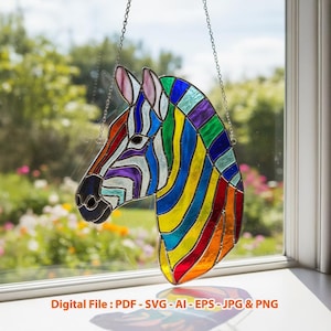 May include: A stained glass zebra head with a rainbow color scheme. The zebra's stripes are a mix of red, orange, yellow, green, blue, and purple. The artwork is hanging by a silver chain in front of a window.