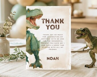 May include: A rectangular thank you card featuring a green Tyrannosaurus Rex illustration on the left side. The text reads: THANK YOU, THANK YOU SO MUCH FOR CELEBRATING MY BIRTHDAY WITH ME AND FOR THE WONDERFUL PRESENT YOU GAVE ME! I HAD SUCH A GOOD TIME PLAYING WITH ALL MY FRIENDS, NOAH.