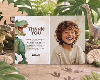 May include: A rectangular thank you card featuring a green dinosaur illustration on the left and a photograph of a smiling child wearing a helmet on the right. The text reads: THANK YOU, THANK YOU SO MUCH FOR CELEBRATING MY BIRTHDAY WITH ME AND FOR THE WONDERFUL PRESENT YOU GAVE ME! I HAD SUCH A GOOD TIME PLAYING WITH ALL MY FRIENDS, NOAH.