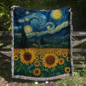 May include: Woven throw blanket featuring a vibrant depiction of Van Gogh's "Starry Night" and sunflowers. The top half showcases a swirling night sky with stars, while the bottom half displays a field of sunflowers. The blanket has a fringed edge.