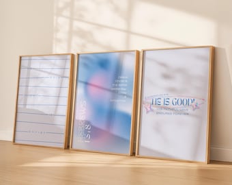 May include: Three framed art prints with gold-colored frames. The prints feature inspirational text and designs in blue, pink, and white. One print reads "the only constant is christ". Another says "HEBREWS 13:8". The third print says "HE IS GOOD!"