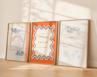 May include: Three framed art prints with inspirational quotes. The prints feature text and graphics in shades of orange, blue, and beige. One print reads "By His Wounds We Are Healed." Another says "Faith It Will Happen." The third says "To Do: Let go, Let God."
