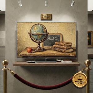 May include: A framed TV art piece depicting a vintage school scene. It features a globe, a chalkboard with "A.B.C.", books labeled "Geography", "Arithmetic", and "History", and a red apple. The artwork is displayed on a wooden shelf.