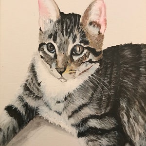May include: A painting of a tabby cat with gray and black stripes. The cat has a white chest and pink ears. The cat is looking directly at the viewer.