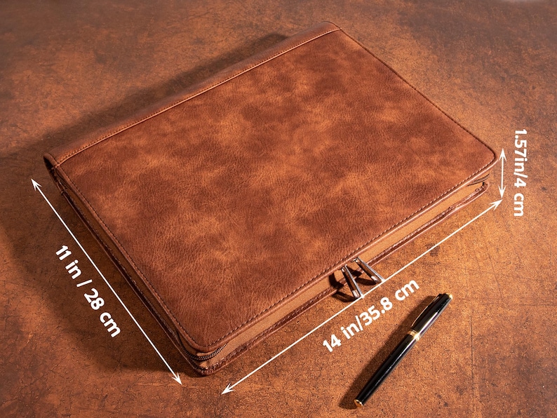 May include: A brown leather zippered portfolio with measurements of 11 inches by 14 inches and 1.57 inches in height.