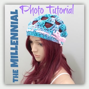 May include: A crocheted hat in a pink and blue colour scheme. The hat features a large openwork design and a pink flower embellishment. The text "Photo Tutorial" and "The Millennial" are visible in the image.