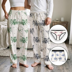 May include: Two pairs of lounge pants with drawstring waists featuring a repeating pattern of dogs and floral elements. One pair has green graphics, the other black. Includes a pair of white briefs and white boxer briefs with dog prints.