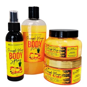 May include: A set of four pineapple mango scented body care products. The set includes a body wash, body spray, whipped body scrub, and body butter. The products are all in clear bottles with yellow labels and feature a pineapple and mango design.