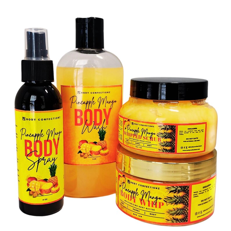 May include: A set of four pineapple mango scented body care products. The set includes a body wash, body spray, whipped body scrub, and body butter. The products are all in clear bottles with yellow labels and feature a pineapple and mango design.