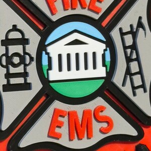 May include: A red and black fire department emblem with the words "FIRE EMS" and "VIRGINIA" in black lettering. The emblem features a white building with columns, a fire hydrant, and a ladder.